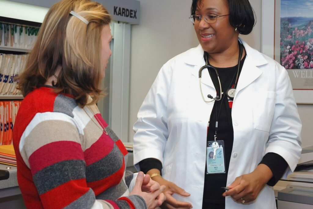 A clinician talking with a patient during a consultation
